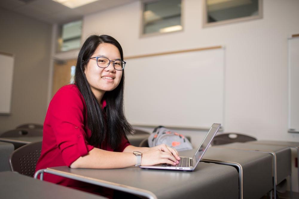 Student, Kindyl King, working at a computer.